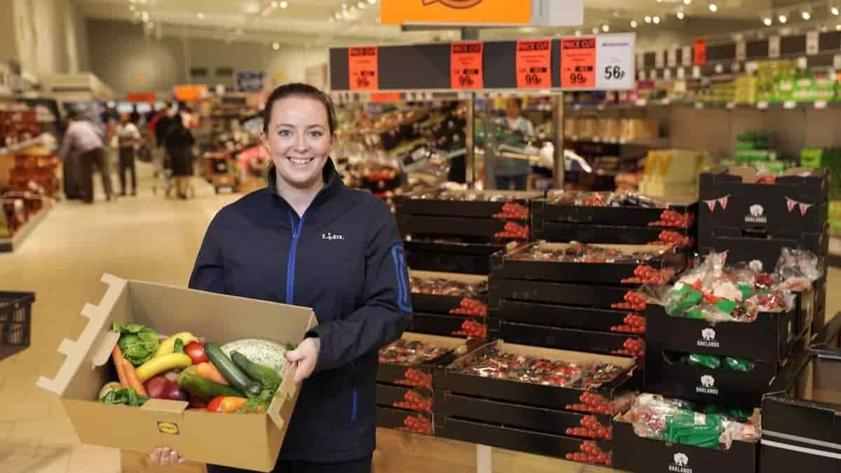 Lidl worker holding a Waste Not box